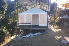 swiss-cottage-tents-pitched-under-corrugated-sheet-